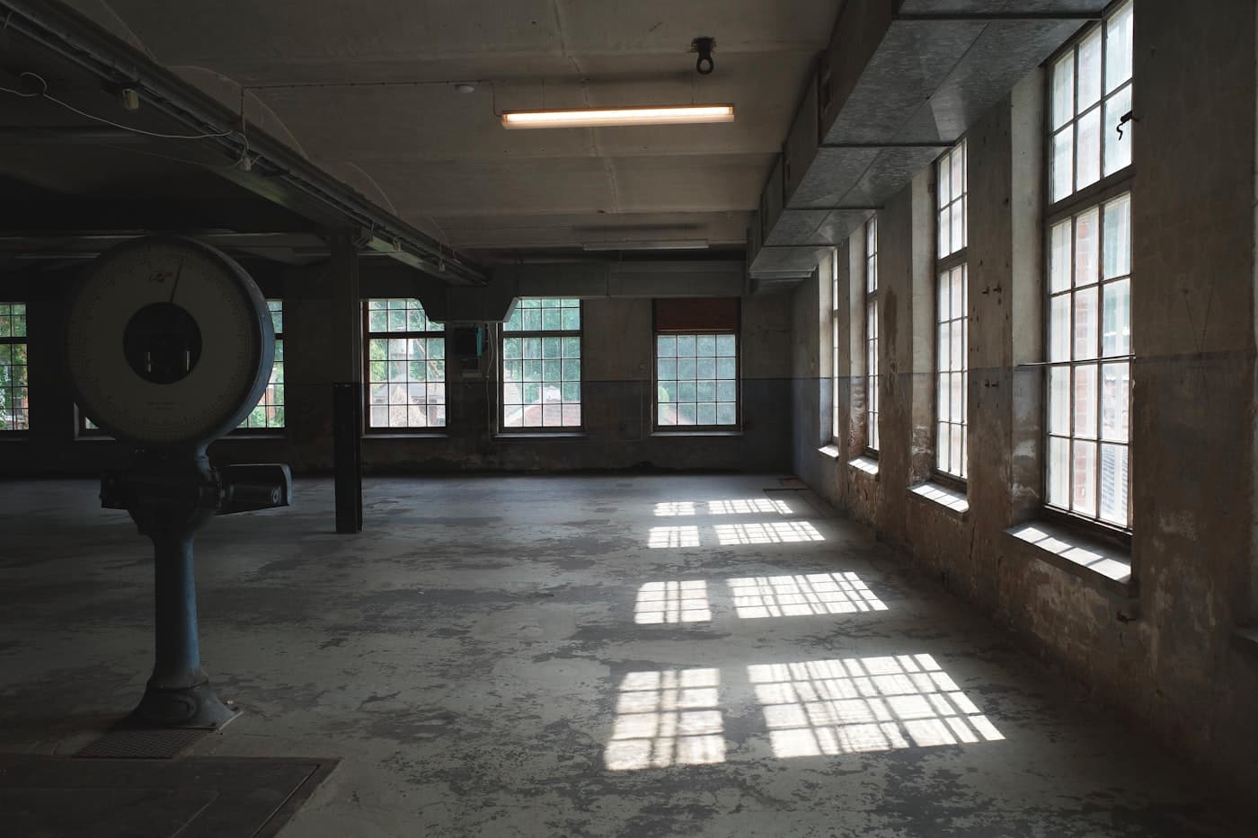 Empty industrial room with dull concrete floor before coating