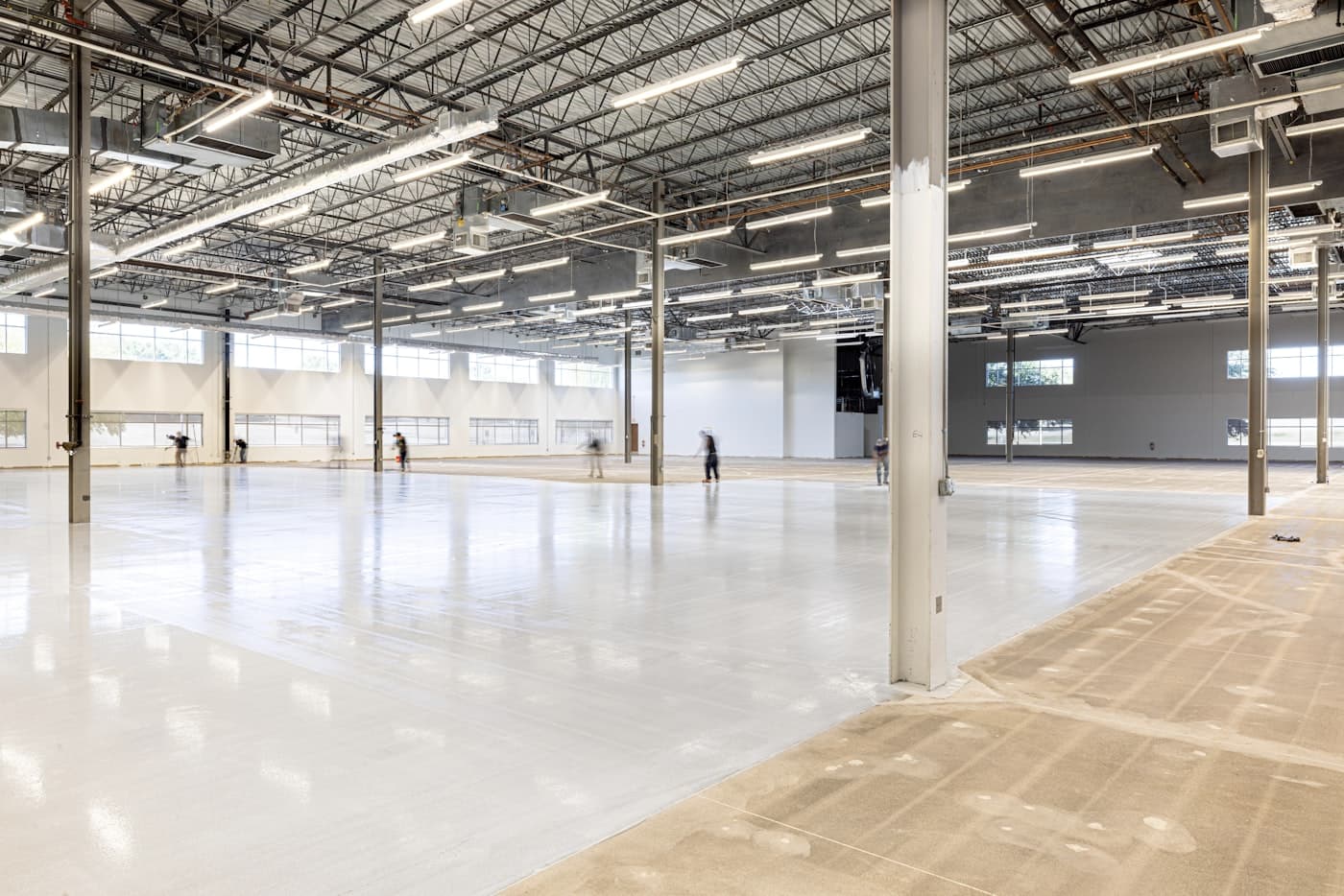 Warehouse with glossy light-gray epoxy floor after coating