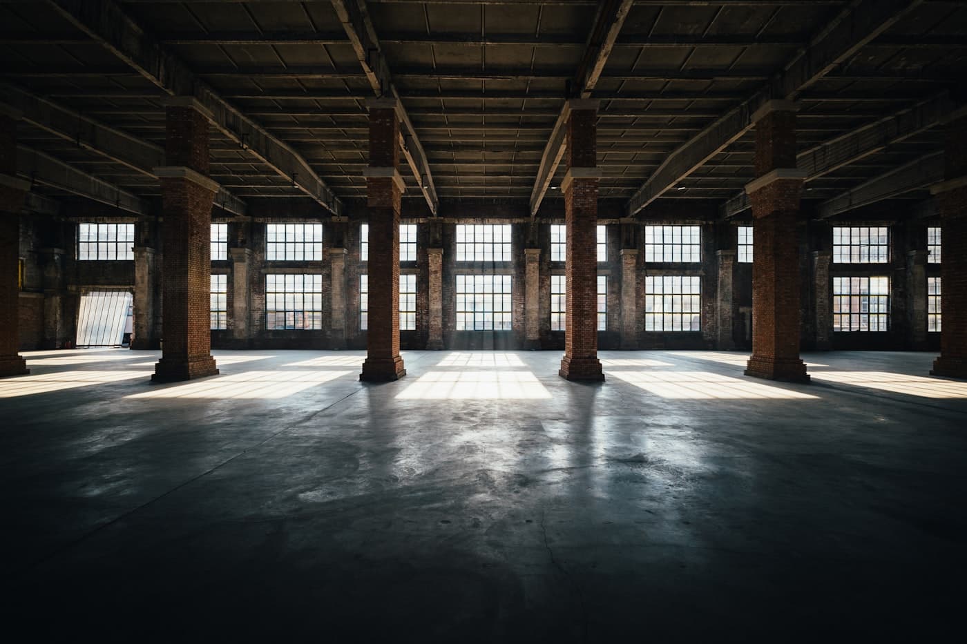 Warehouse with worn bare concrete floor before coating